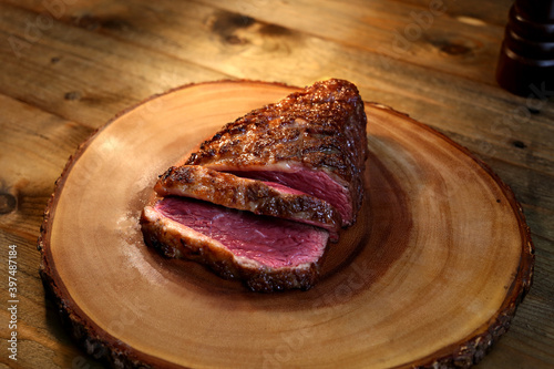 Picanha. Traditional Brazilian barbecue with steak in background.  photo