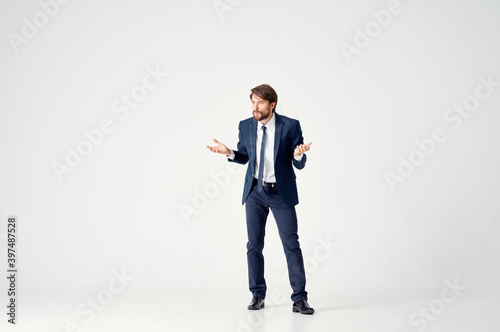 Gentleman in a suit on a light background gestures with his hands work business finance model © SHOTPRIME STUDIO