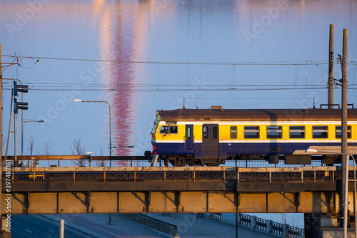 Electric train passing the bridge over Daugava in Riga