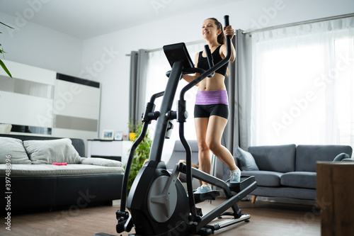 Woman Training On Elliptical Trainer