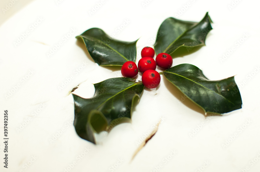 Christmas cake decorated with holly leaves Christmas cake decorated with holly leaves