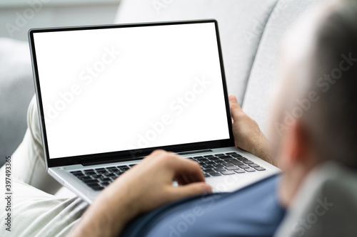 Guy Sitting On Sofa Using Laptop