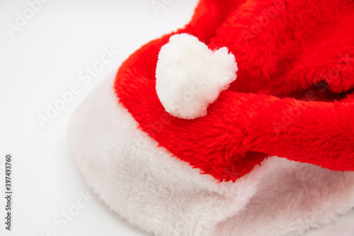 Santa Claus hat on white table with blank space to the left side.