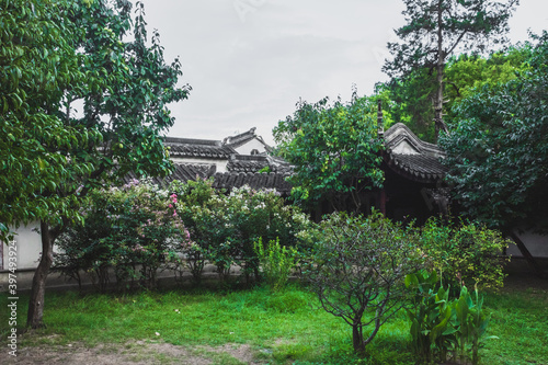 Traditional Chinese architecture between trees at Lingering Garden Scenic Area, Suzhou, Jiangsu, China