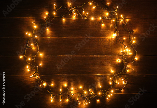 circle vignette christmas lights on the wood background