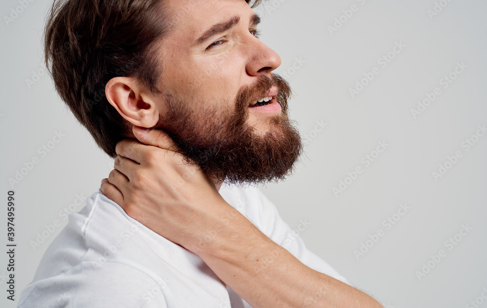 young man touching neck with hands spine pain side view model portrait young man touching neck with hands spine pain side view model portrait