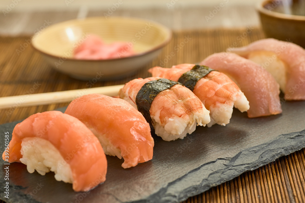 Closeup shot of salmon nigiris on a board Closeup shot of salmon nigiris on a board