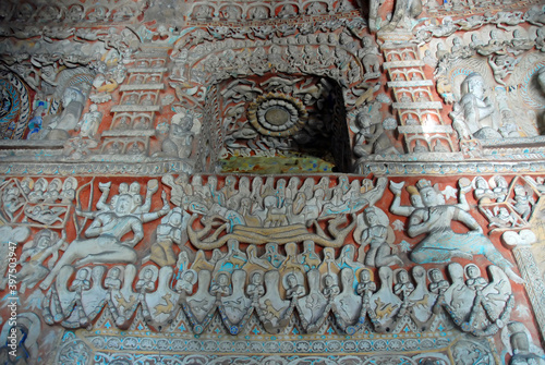 Yungang Grottoes near Datong in Shanxi Province, China. Colorful interior of a cave at Yungang with many small detailed sculptures. Yungang Buddhist cave art and sculptures UNESCO world heritage. photo