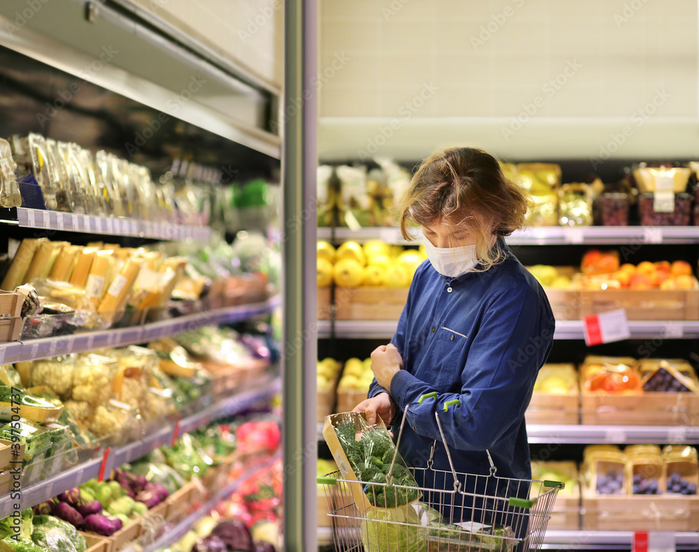 Supermarket shopping, face mask and gloves,man buying vegetables at the market.