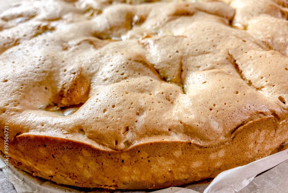The close up of the cooked sponge cake with apples, top view. Food textures. The close up of the cooked sponge cake with apples, top view. Food textures.