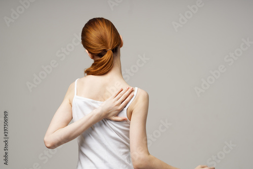 woman white t-shirt touching her shoulders with hands cropped view close-up photo