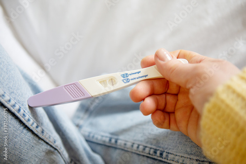 Woman looking on positive pregancy test