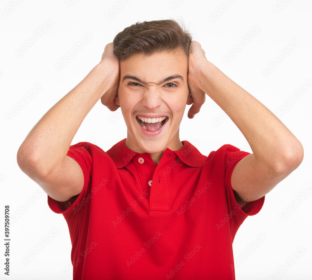 Photo of young screaming man looking at camera isolated on white background. Portrait of handsome guy touching his head with a expressive emotions . Funny portrait of Teenager . Photo of young screaming man looking at camera isolated on white background. Portrait of handsome guy touching his head with a expressive emotions . Funny portrait of Teenager .