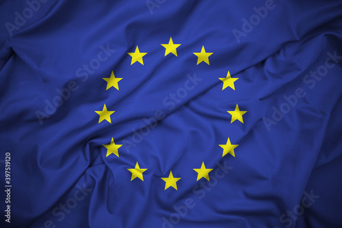 EU Flag, Symbol of the European Union. Twelve Five-Pointed Yellow Stars on a Blue Background. Silk Fabric, Delatiled Texture. High Resolution