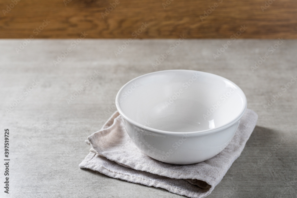 white empty pot bowl to put fruits or ice cream on a wooden table background. copy space white empty pot bowl to put fruits or ice cream on a wooden table background. copy space
