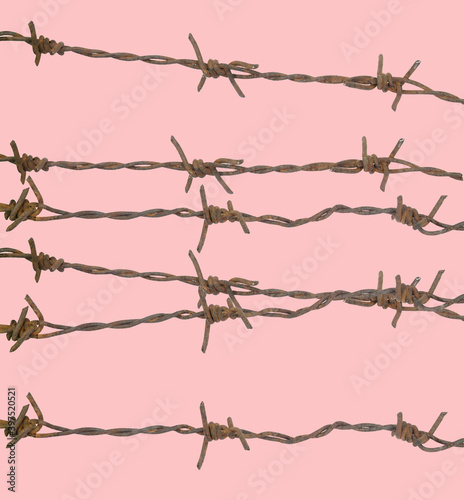 Rusty barbed wire on a colorful background
