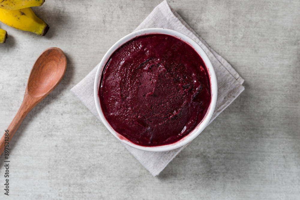 Brazilian frozen açai berry ice cream bowl. with fruits on wooden background. Summer menu top view. close up Brazilian frozen açai berry ice cream bowl. with fruits on wooden background. Summer menu top view. close up