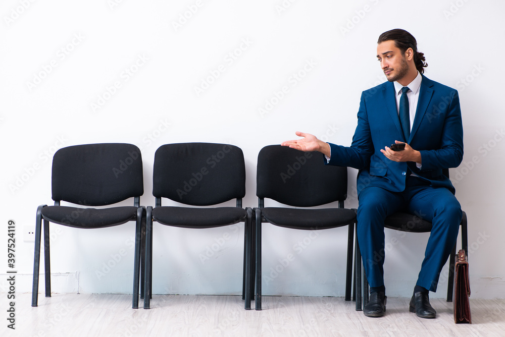 Young businessman waiting for an interview at hall Young businessman waiting for an interview at hall