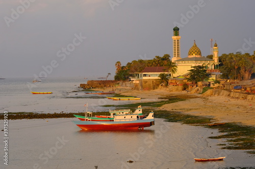 Indonesia Kupang - City Coastline with fishing boats and the Mosque Nurul Hidayah photo