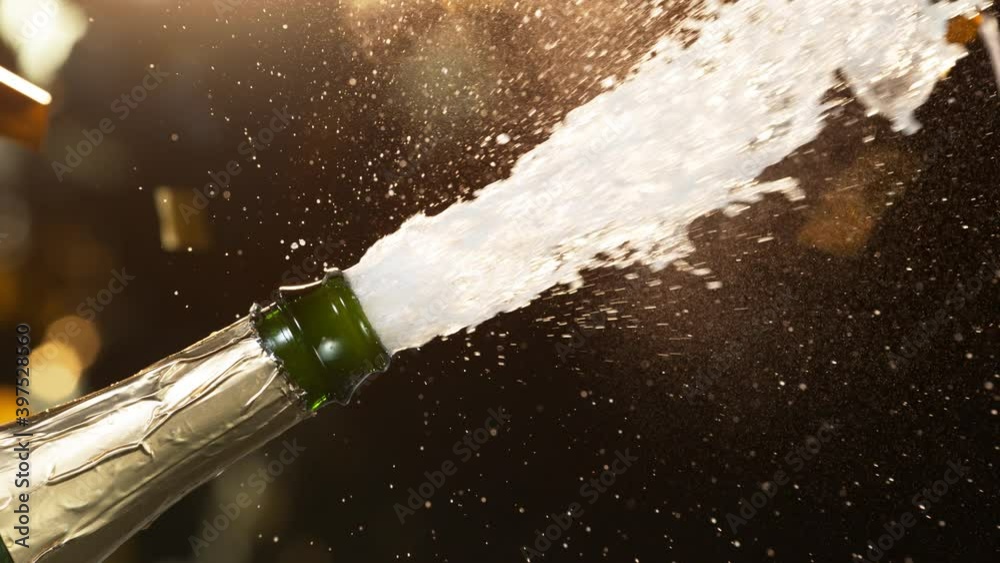 Super slow motion of Champagne explosion, opening champagne bottle closeup. Filmed on high speed cinema camera, 1000fps