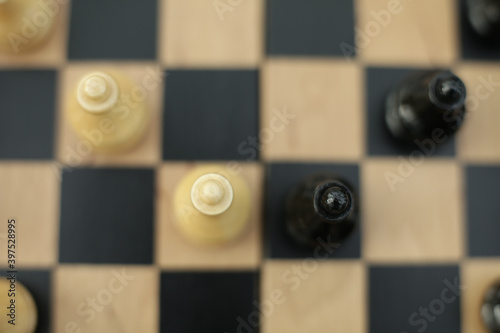 Wood chess pieces on a board