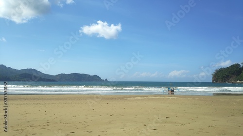 beach with boats and cloudy blue sky Potrait