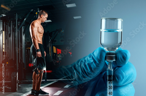 Bodybuilder in the gym, injecting a steroid syringe. Strong athletic muscular man, workout, fitness and bodybuilding. Healthy and unhealthy supplements to increase muscle mass. photo