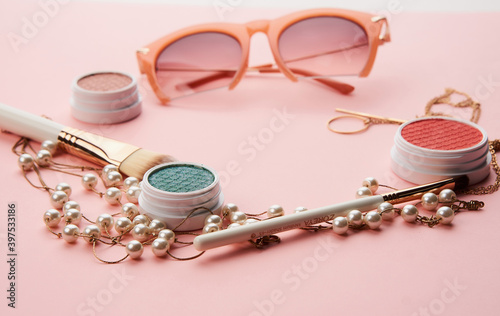 Cosmetics womens accessories jewelry glasses pink background