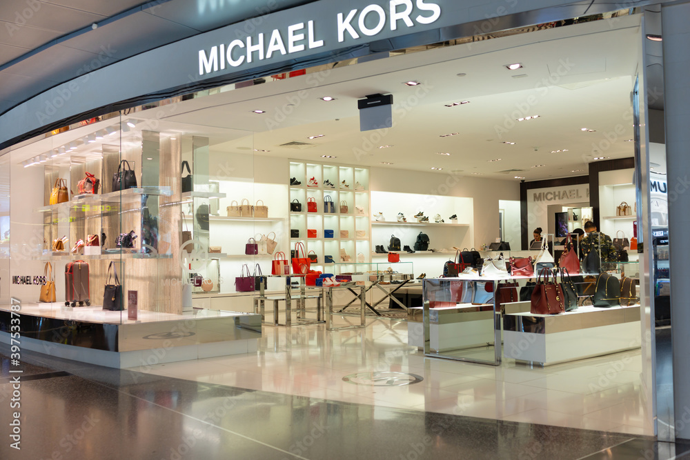View of the Michael Kors store in Hamad International Airport. Michael Kors  is an American luxury fashion company that was established in 1981. DOHA,  QATAR - 31 OCT 2019. Stock Photo | Adobe Stock