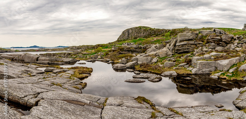 Natural water pool and Fjoloy coastline near fortress historical site, Rennesoy kommune, Stavanger, Norway, May 2018 photo