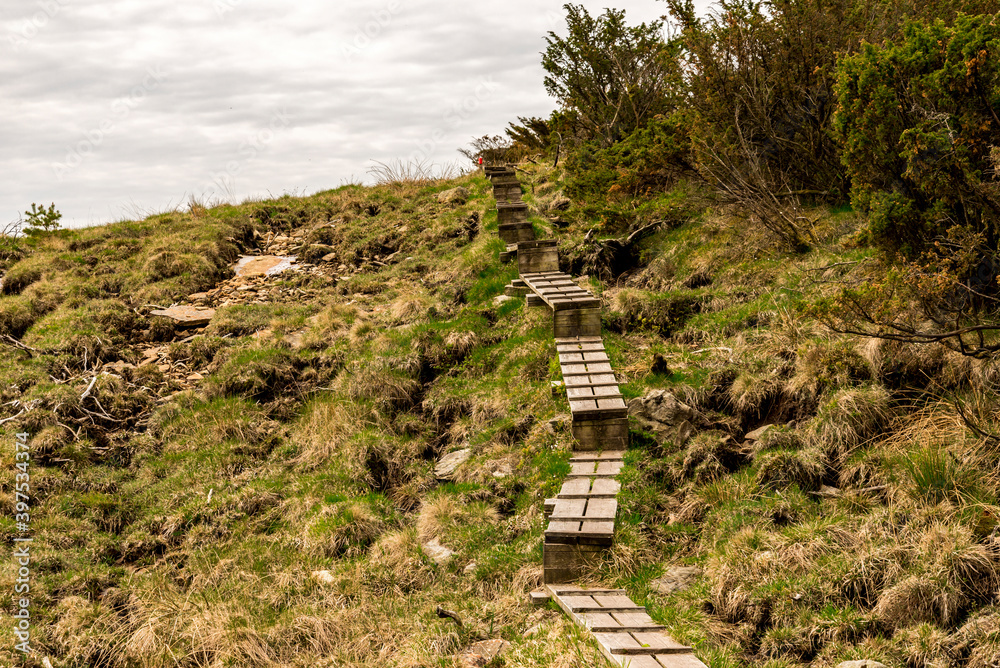 Wooden boardwalk steps on a hiking track to Mastravarden at Mosteroy island, Rennesoy commune, Stavanger, Norway, May 2018