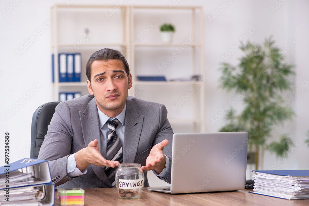 Young male employee in pension concept at workplace