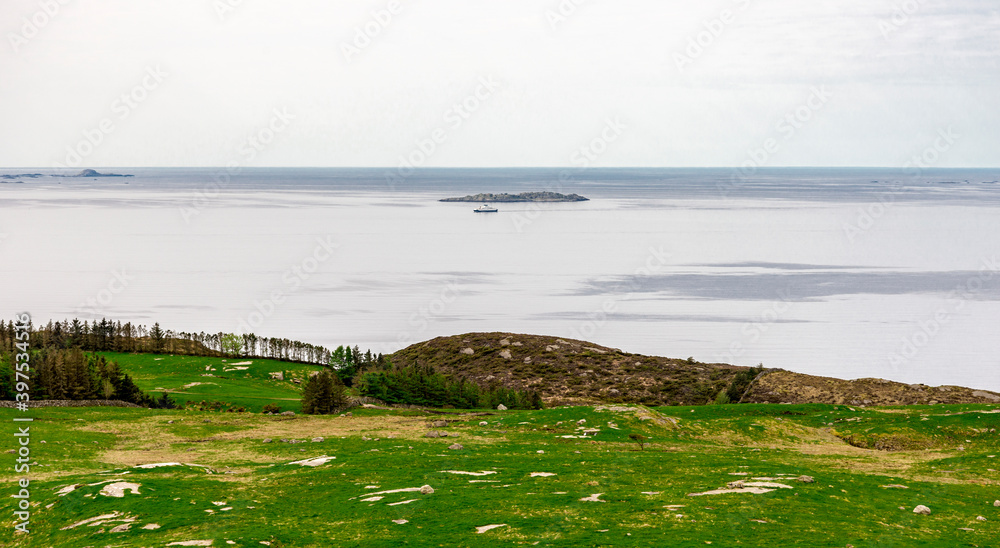 A view to the ferry from Kvitsoy island from Mastravarden hill on Mosteroy, Rennesoy kommune, Norway, May 2018