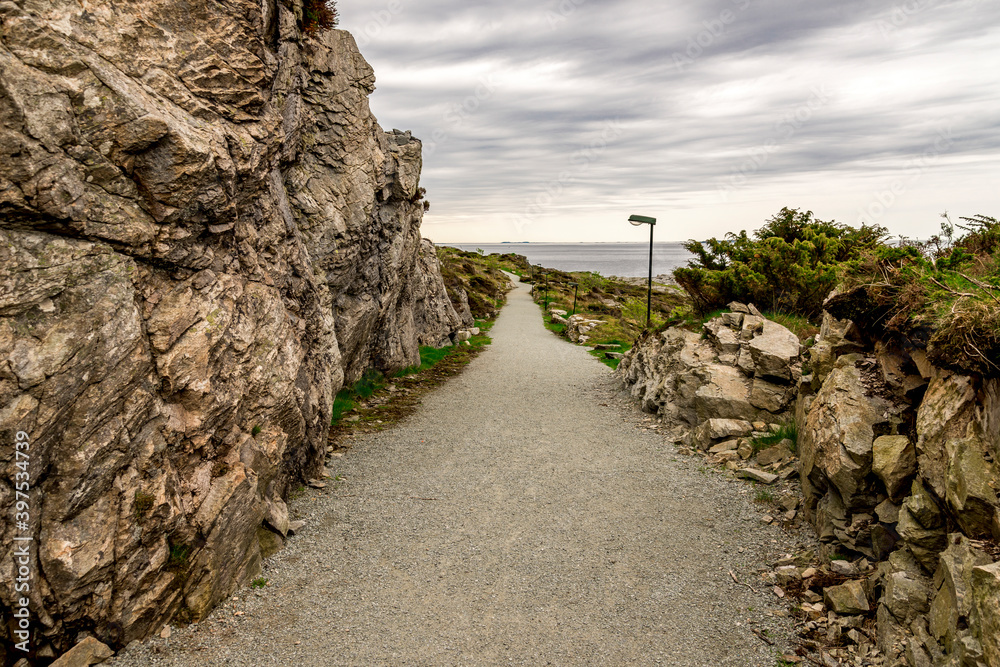 A long footpath leading to remains of the historical Fjoloy fort site, Rennesoy kommune, Stavanger, Norway, May 2018