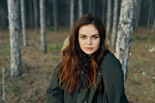 Pretty woman in a jacket in the woods attractive look nature travel