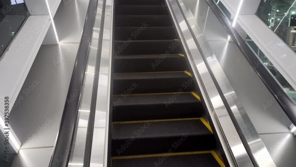 Empty working escalators stairway with a yellow stripes. Empty working escalators stairway with a yellow stripes.