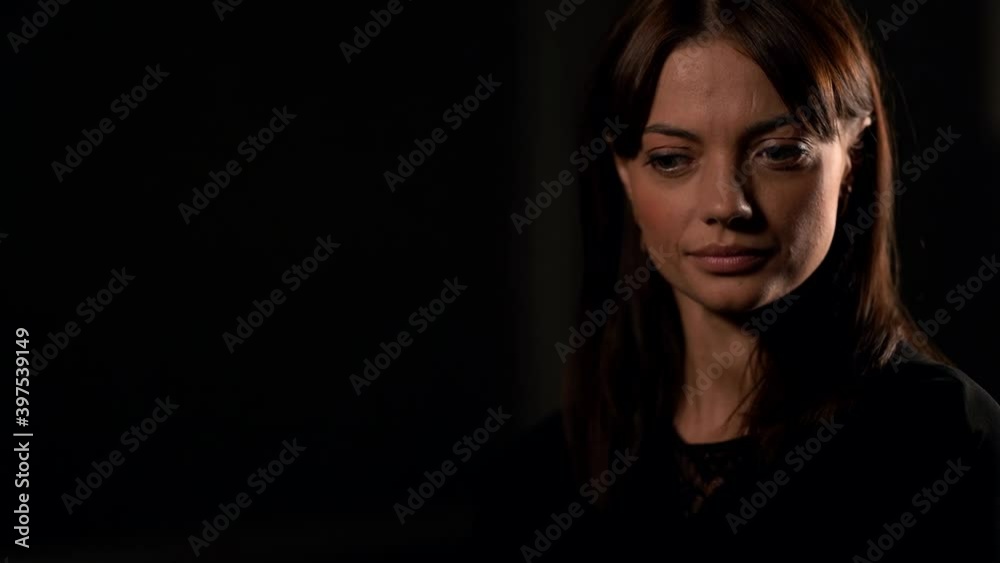 Portrait of a young beautiful brunette woman with natural beauty. Located in the Studio on a black background. Portrait of a young beautiful brunette woman with natural beauty. Located in the Studio on a black background.