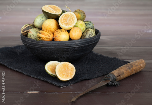 Organic Fresh Healthy Vegetable Yellow Cucumbers or Yellow Pumpkin on Wooden Background photo