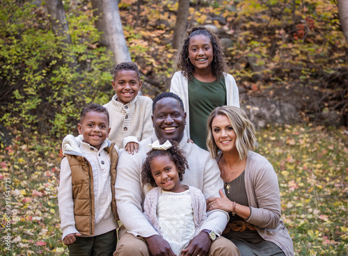 Posed Mixed Race family portrait outdoors with autumn colors © Brocreative