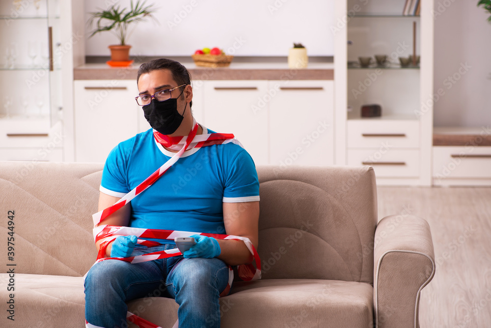Young man watching tv at home in pandemic concept Young man watching tv at home in pandemic concept
