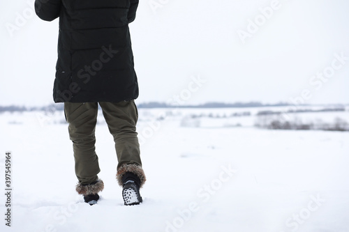 Bearded man in the winter woods. Attractive happy young man with beard walk in the park.