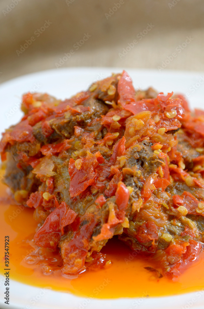 Dendeng Balado or Dendeng Batokok, and is a speciality from Padang, West Sumatra, Indonesia. Made from beef which is thinly cut then dried and fried before adding chillies and other ingredients
