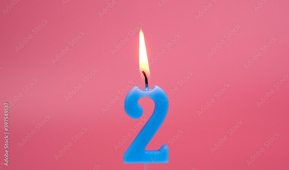 Light a candle number 2 on pink background. Light a candle number 2 on pink background.