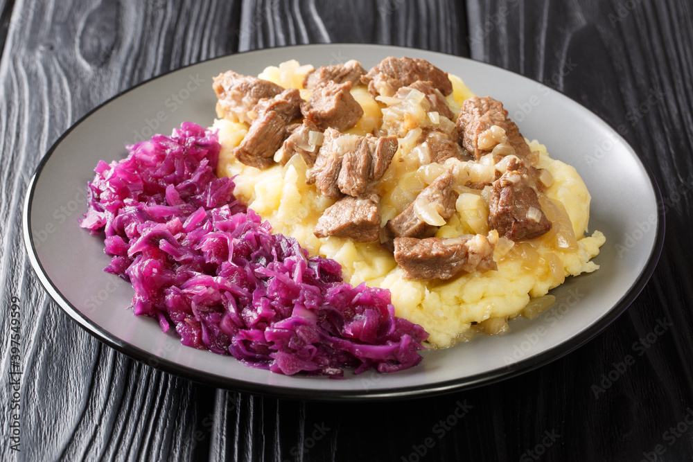 Dutch cuisine beef and onion stew served with mashed potatoes and red cabbage close-up in a plate on the table. horizontal