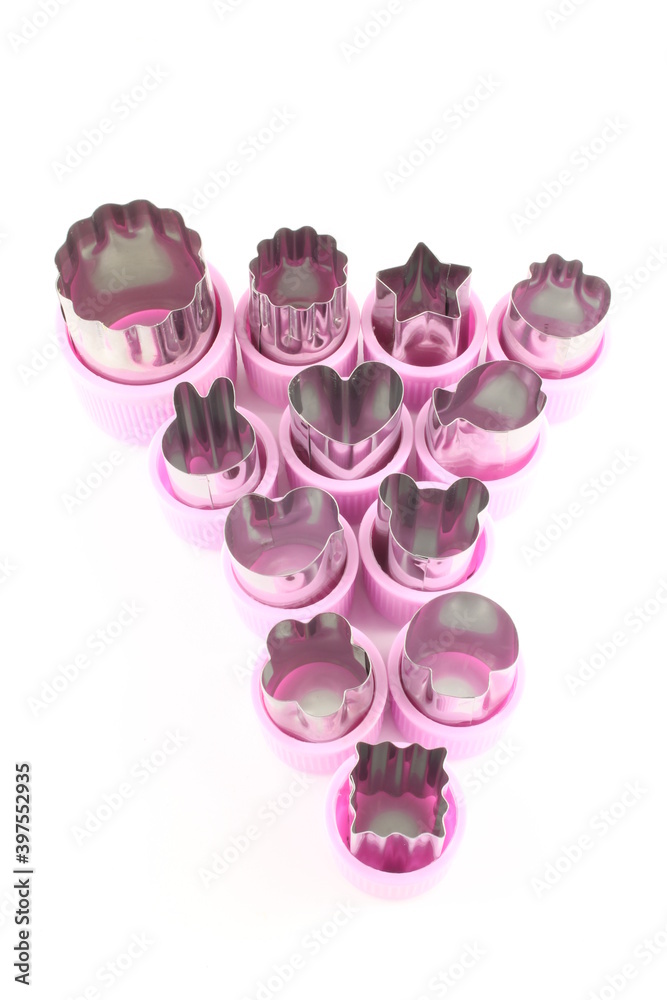 Fototapeta premium Mini fruit vegetable and cookie cutters isolated on a white background with copy space