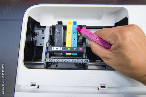 Technicians are install setup the ink cartridge of a inkjet printer the device of office automate for printing © piyaphunjun