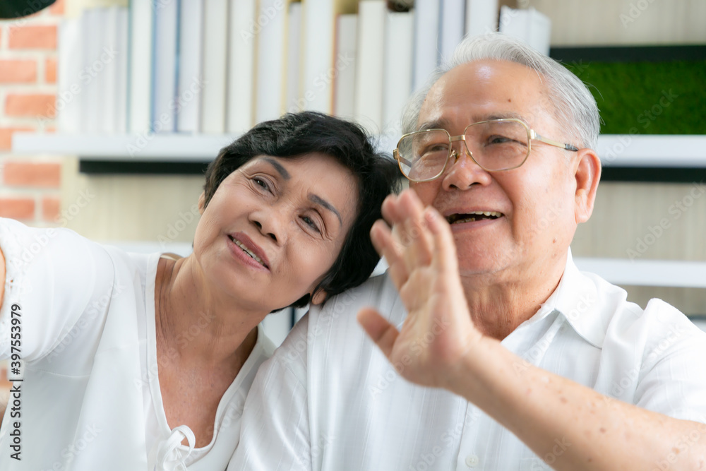 Senior Asian wife and husband using video call to daughter with happy smiling face. Social distancing. Senior Asian wife and husband using video call to daughter with happy smiling face. Social distancing.