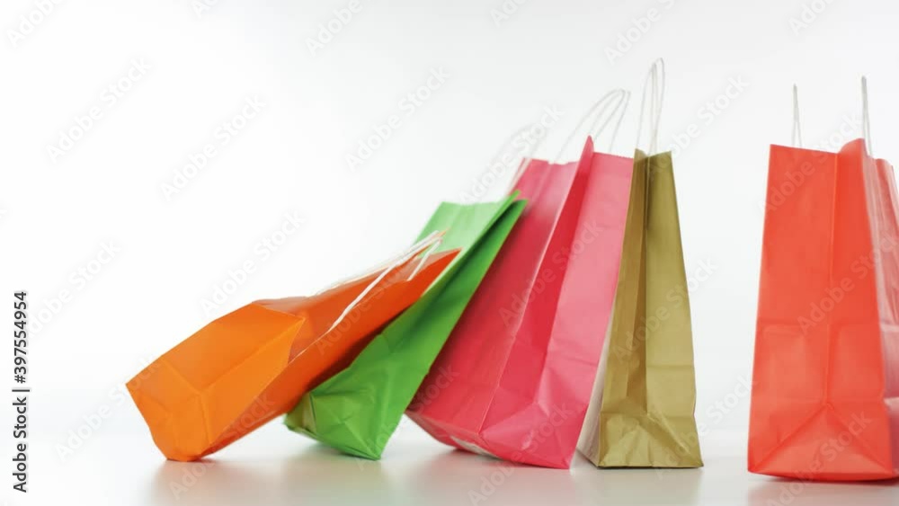 Color paper bags fall down, slow motion shot. Shopping concept Color paper bags fall down, slow motion shot. Shopping concept