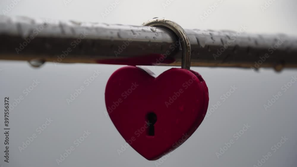Red heart shaped padlock on metal railing of bridge. Love locks in the ...
