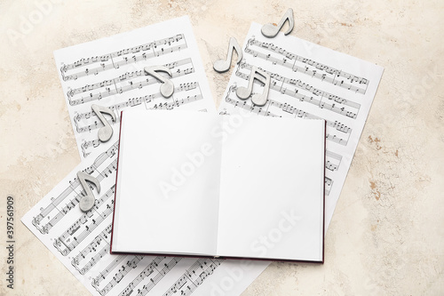 Blank book with music notes on white background photo